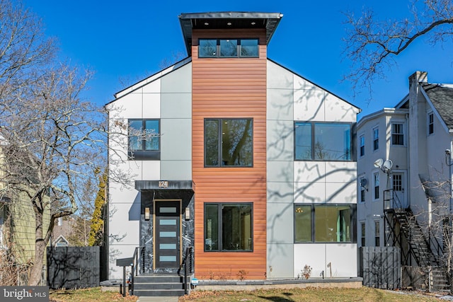 contemporary home featuring fence