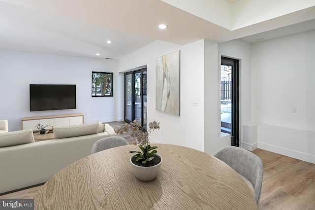 dining space featuring baseboards, wood finished floors, and recessed lighting