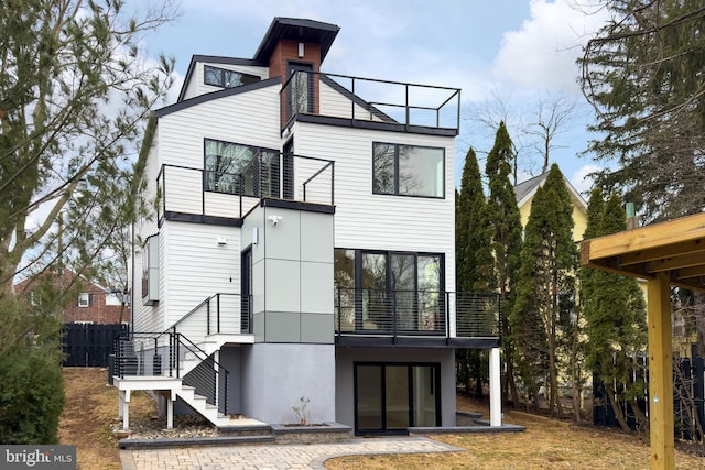 rear view of property featuring a balcony