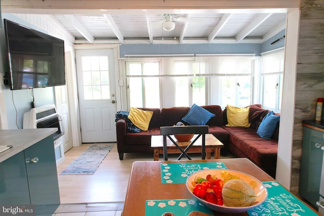 living room featuring beamed ceiling, wooden ceiling, light wood-style flooring, and heating unit