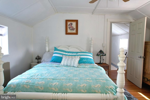 bedroom featuring lofted ceiling, wood finished floors, and a ceiling fan