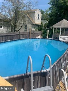 pool featuring a gazebo and fence