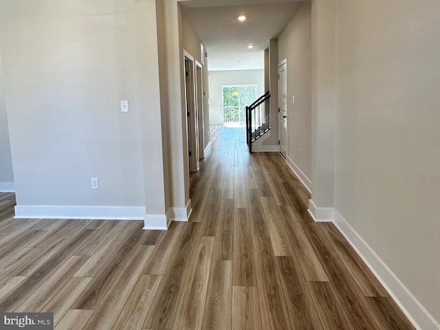 hall with recessed lighting, dark wood finished floors, stairway, and baseboards