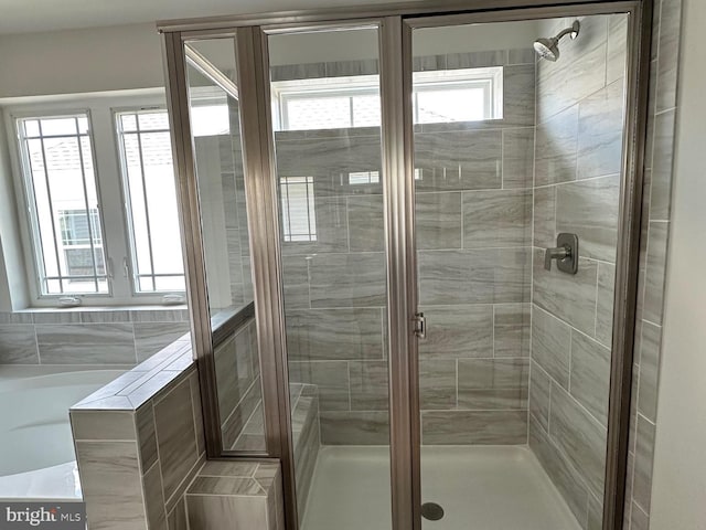 full bath with a shower stall and a tub