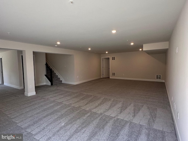 basement featuring recessed lighting, carpet flooring, visible vents, baseboards, and stairs