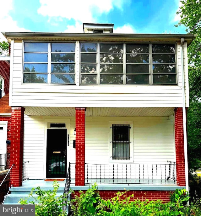 view of front of property with a porch and brick siding