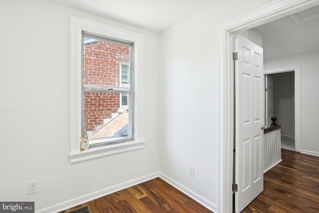 interior space with dark wood-type flooring, plenty of natural light, and baseboards