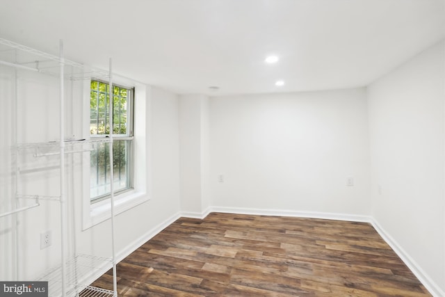 unfurnished room with recessed lighting, wood finished floors, and baseboards