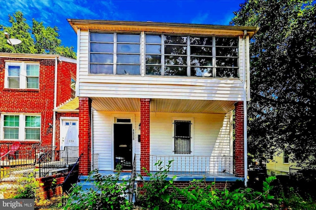 view of front of property featuring a porch and brick siding