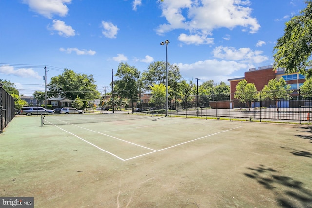 view of sport court featuring fence