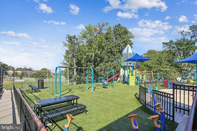 community playground with fence and a lawn