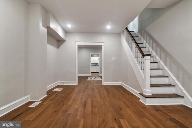 interior space with hardwood / wood-style flooring, visible vents, baseboards, and recessed lighting