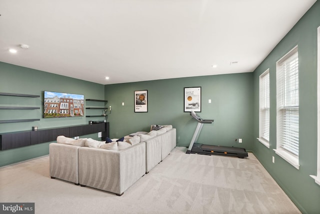 carpeted living area with visible vents, recessed lighting, and baseboards