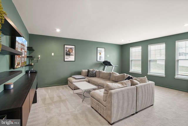 living area with recessed lighting, baseboards, and light carpet