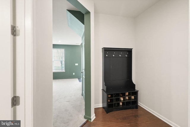 interior space featuring baseboards and wood finished floors