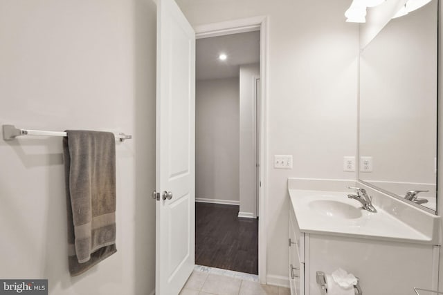 bathroom with vanity, tile patterned floors, and baseboards