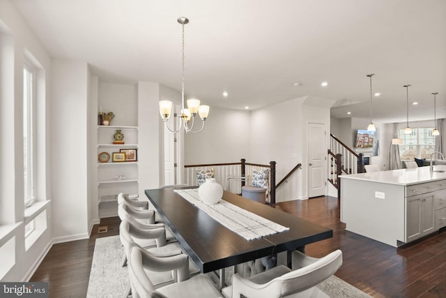 dining room with baseboards, dark wood finished floors, recessed lighting, stairs, and a notable chandelier