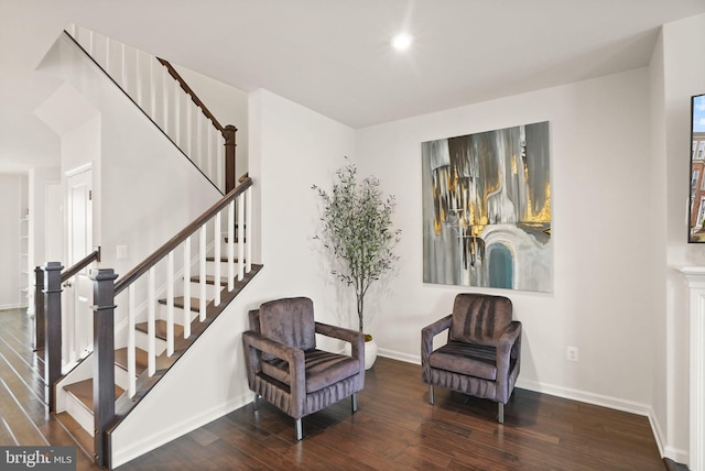 sitting room featuring recessed lighting, stairs, baseboards, and wood finished floors