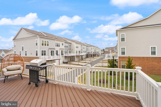 deck featuring grilling area and a residential view