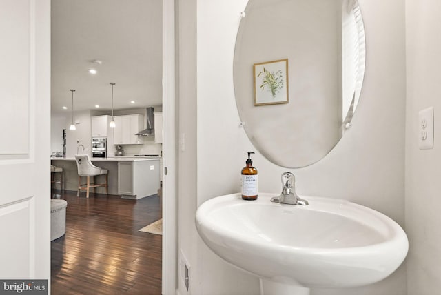 bathroom featuring recessed lighting, hardwood / wood-style flooring, and a sink