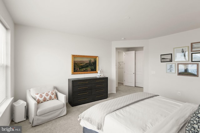 bedroom with multiple windows and light colored carpet