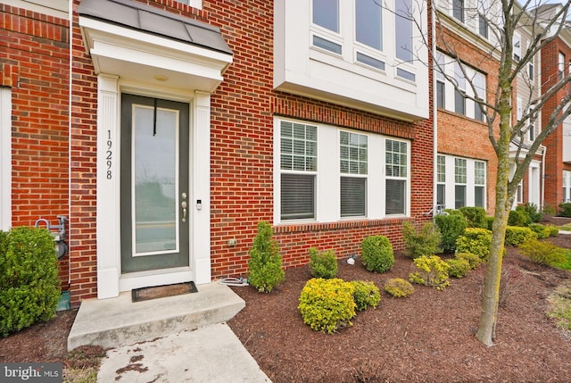 doorway to property with brick siding