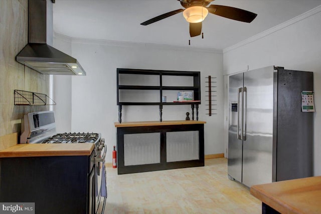 kitchen featuring a ceiling fan, appliances with stainless steel finishes, wall chimney exhaust hood, and crown molding