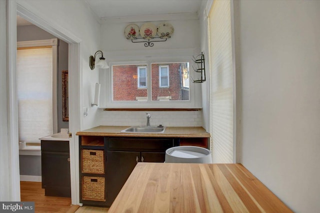 bathroom with tasteful backsplash, vanity, and wood finished floors