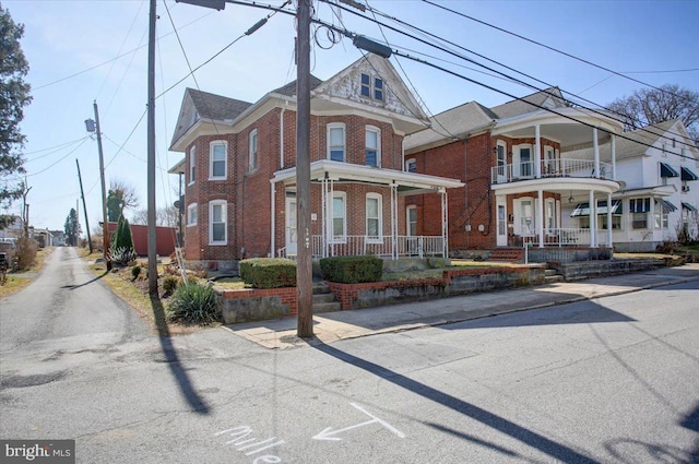 view of front of property featuring brick siding and covered porch