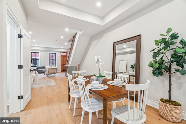 dining space with light wood-type flooring and recessed lighting