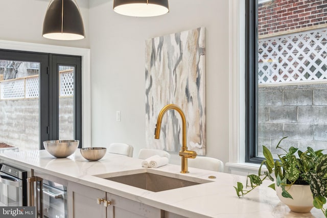 interior space with a sink and decorative light fixtures