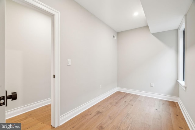 unfurnished room with light wood-style flooring and baseboards