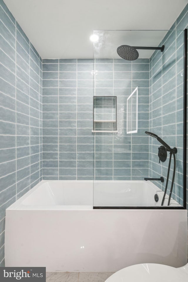 full bathroom featuring shower / bathtub combination and tile walls