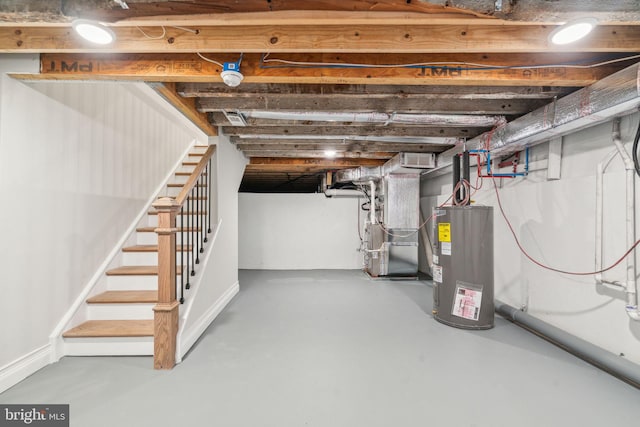 unfinished below grade area with heating unit, stairs, water heater, and visible vents