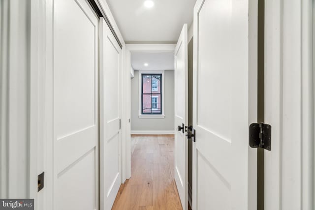 hallway with recessed lighting and light wood-style flooring