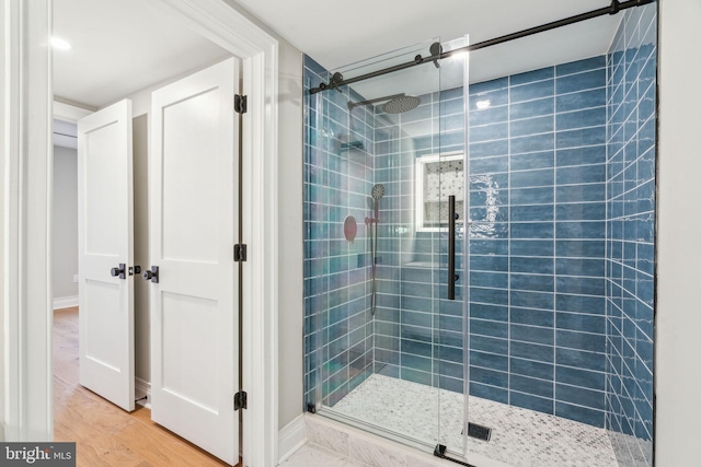 bathroom featuring a stall shower and wood finished floors