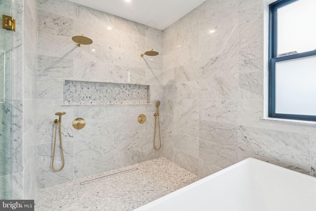 bathroom featuring a bathtub and tiled shower