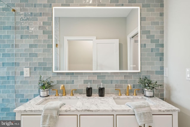 full bath featuring tasteful backsplash, a sink, and double vanity