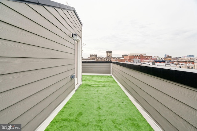 view of yard featuring a balcony and a view of city