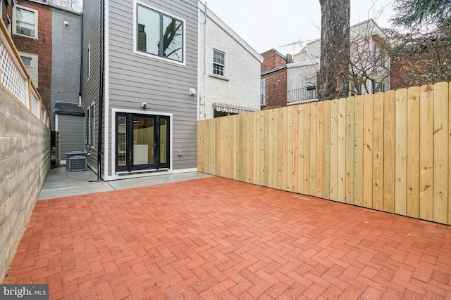 back of property with a patio, central AC unit, and fence