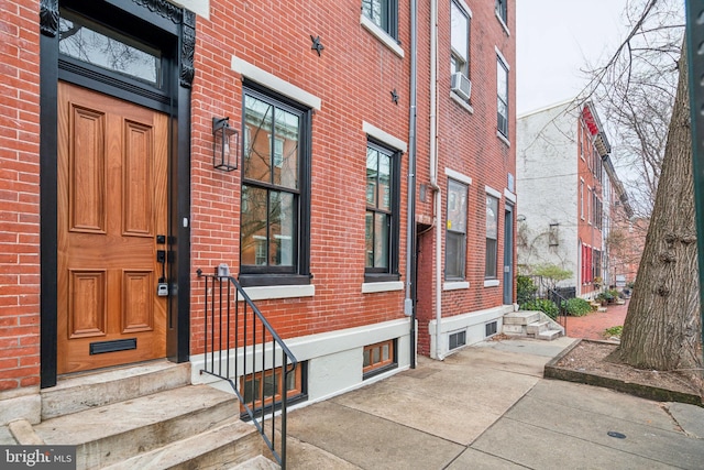 doorway to property featuring brick siding