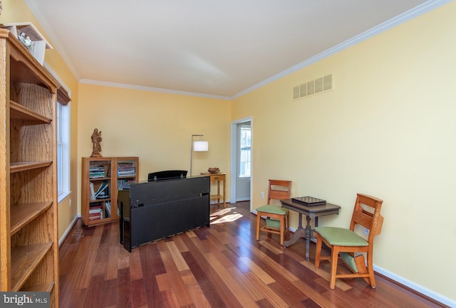 office featuring ornamental molding, visible vents, baseboards, and wood finished floors