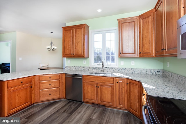 kitchen with dark wood-style floors, stainless steel appliances, brown cabinetry, a sink, and a peninsula