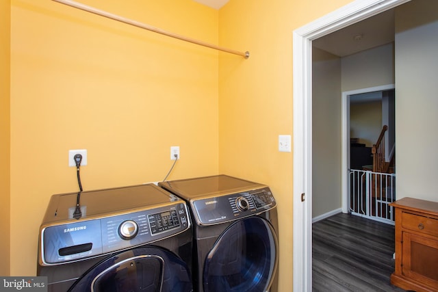 laundry area with laundry area, wood finished floors, and washer and dryer