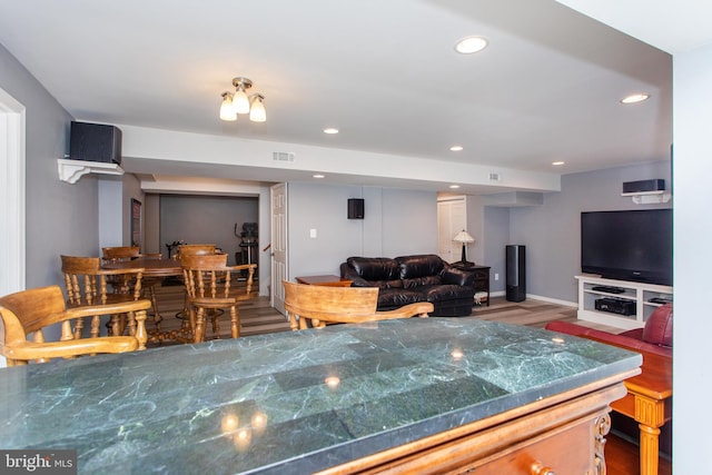 kitchen with recessed lighting, open floor plan, visible vents, and wood finished floors