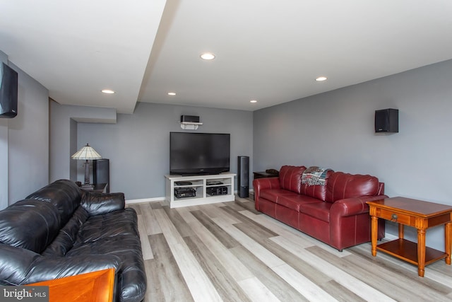 living room with light wood-style floors, baseboards, and recessed lighting