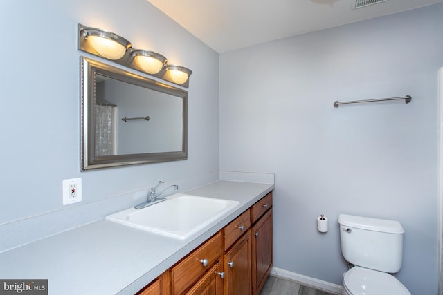 full bathroom with visible vents, vanity, and toilet