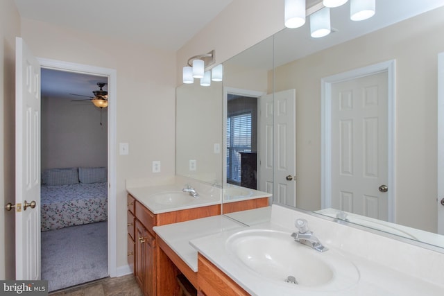 ensuite bathroom with double vanity, a sink, and connected bathroom