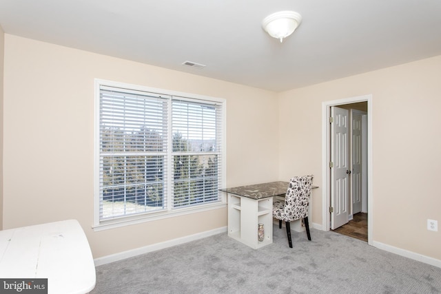 carpeted office space with baseboards and visible vents