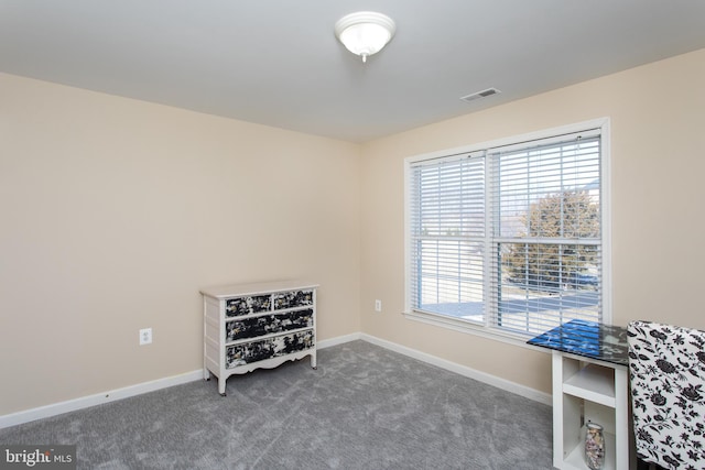 interior space featuring baseboards, visible vents, and carpet flooring